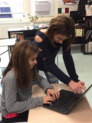 student working on a piece of their work 
